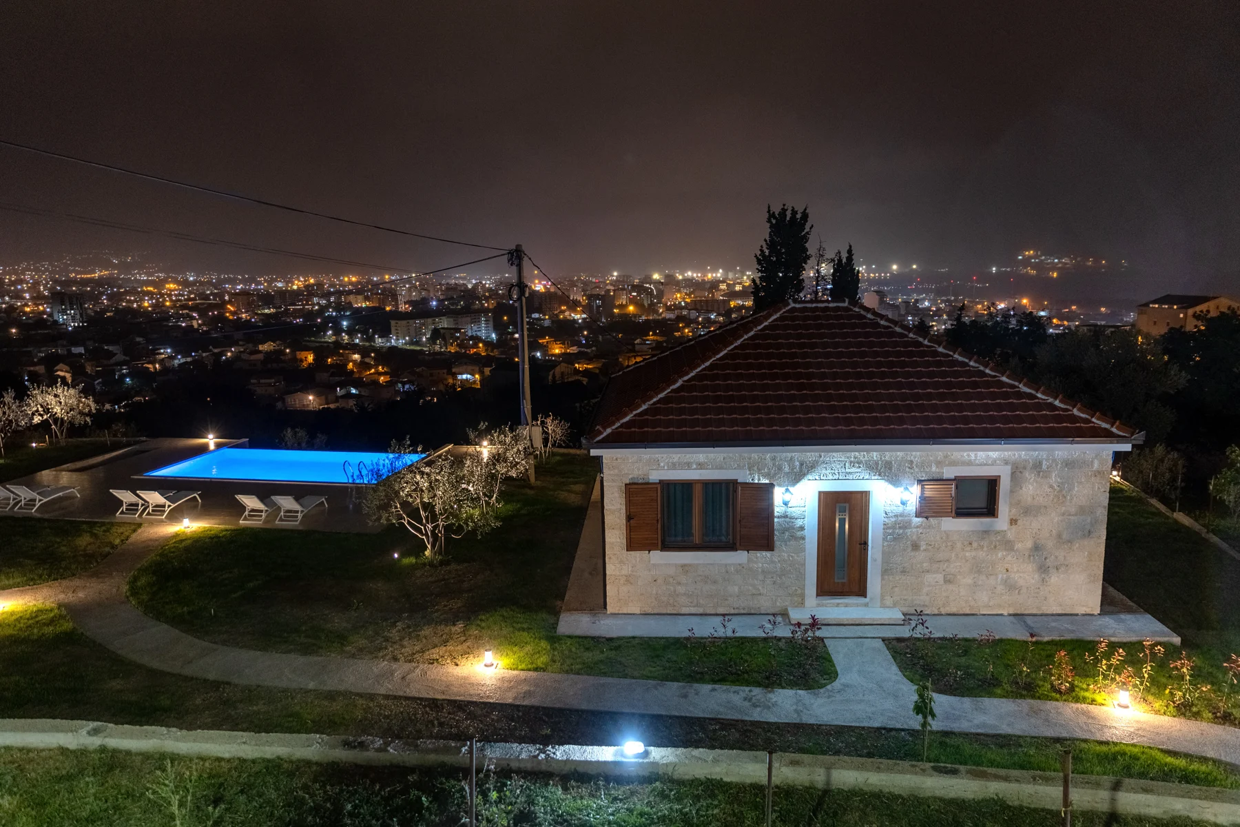 Pool Villa, shared pool and the lights of Bar at night